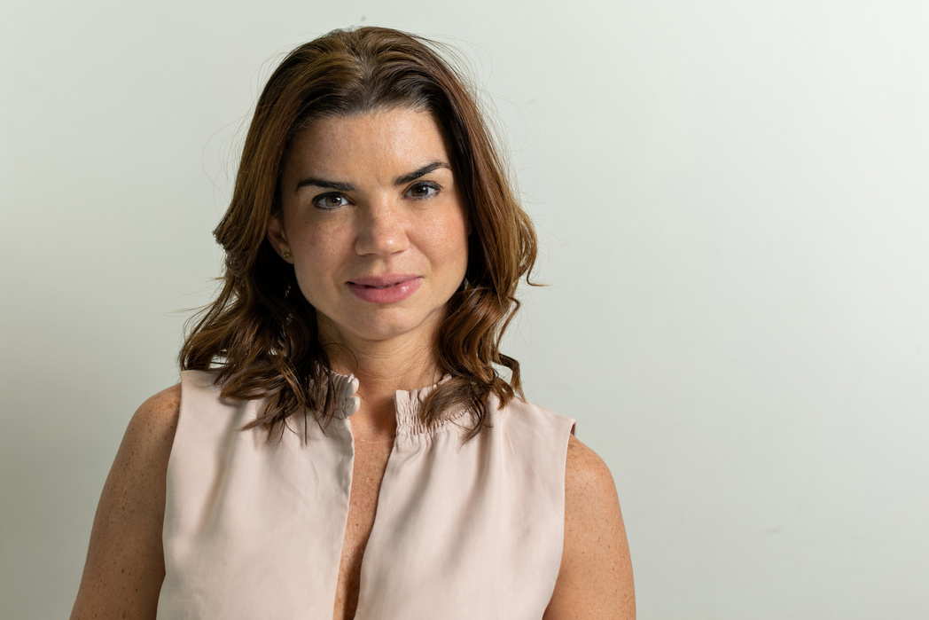 Mature 38 years old woman, looking straight at the camera in her home office.